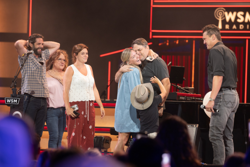 Akins' family surprises him center stage after he was officially invited to become an Opry member. Photos credit: © Grand Ole Opry, photos by Chris Hollo